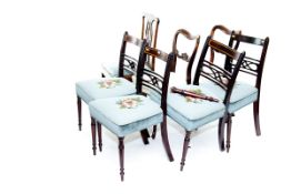 A set of three mahogany and crossbanded William IV dining chairs with turned front supports, a