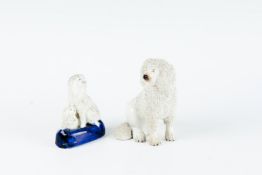 A 19th Century Staffordshire pottery seated white speckled poodle dog with separate front legs;
