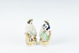A pair of 19th Century Staffordshire pottery figures - seated peasant girl and seated peasant boy,