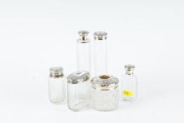 A hobnail cut glass hair tidy with titled silver top; and five silver topped dressing jars