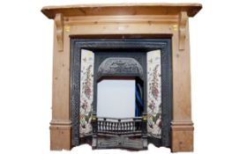 A pine surround, cast iron fireplace with floral tiled uprights
