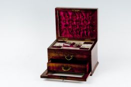 A fine quality walnut box, the hinged lid revealing a compartmented tray with a few instruments