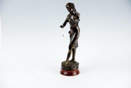 A heavy metallic figurine of standing lady in flowing dress with arms outstretched, 20 ins (51