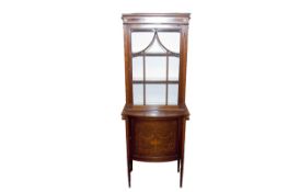 An Edwardian mahogany and inlaid narrow display cabinet, the upper section having a single door with