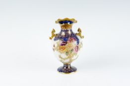 A large Carltonware bulbous vase with floral gilt and blue panelled decoration and with twin gilt
