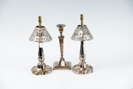 A pair of circular based electroplated table lamps, approximately 11 ins (28 cms) high and a