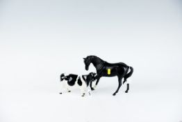 A Beswick Pottery Friesian cow `Claybury Legwater`; and a Royal Doulton black matt stallion, head to