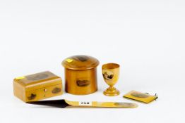A circular lidded oblong box; an oblong box; an egg cup; a needle case; and a letter opener