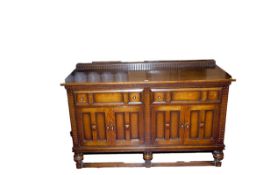 An early 20th Century polished railback sideboard having two drawers and double door cupboards