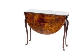 An early 20th Century oval mahogany tea table on cabriole supports and castors, 44 ins long (112