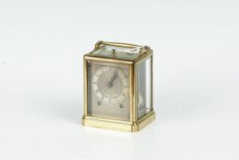 A brass encased ultra large carriage clock having bevelled glass panels, a silvered dial and with