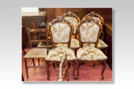A set of four reproduction mahogany effect drawing room chairs with floral padded backs and seats;