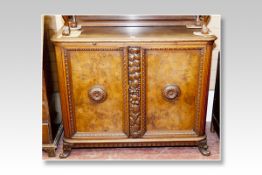 A Biedermeier style walnut and oak sideboard having a rail back and with two inset walnut panelled