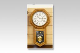 A polished encased octagonal framed Ansonia Regulator pendulum wall clock