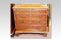 A compact oak and pine chest of four long graduated drawers with brass swan neck handles, 29 ins (74