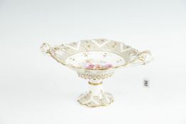 An early to mid 19th Century Staffordshire comport having a circular base, scrolled gilt handles