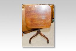 A Victorian mahogany oblong tilt topped tripod table on three curved supports