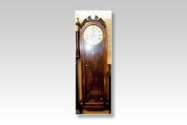 An early Victorian dome topped glass door pendulum wall clock having carved animal finials, a