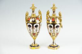 A pair of Royal Crown Derby `Old Imari` twin handled vases, each on square shaped bases, twin gilt