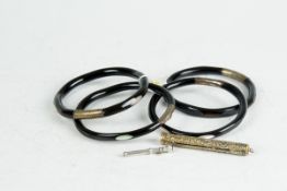 Five ebonised circular bangles with believed silver bands and mother-of-pearl inlays