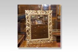 A good wall mirror in a giltwood scrolled and leaf frame, glass size 23 x 17 ins (59 x 43 cms)