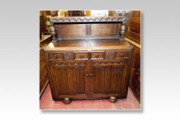 A mid 20th Century polished buffet sideboard having a hooded back to a base of two drawers and two
