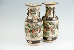 A pair of early 20th Century large Satsuma crackle glazed vases profusely decorated with warriors