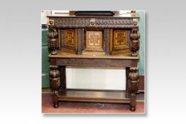 An 18th Century and later parts oak buffet style waiter cupboard having a carved scrolled panel