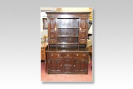 A good 18th Century oak dresser base having a centre box drawer with twin fielded panels below and a