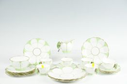 An Aynsley twenty-two piece white ground green and gilt decorated tea set, each cup and the cream
