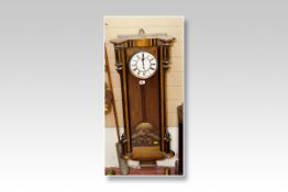 A walnut and ebony encased Vienna single weight pendulum wall clock