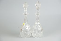 A handsome pair of bulbous narrow neck cut decanters with knopped stoppers