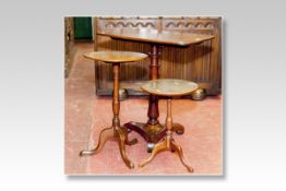 An early Victorian mahogany oblong tilt topped tripod table on a turned centre support and