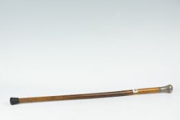 A gentleman`s walking cane with silver top