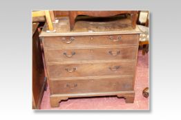 A 19th Century chest of four long graduated drawers with brass swan neck handles (for