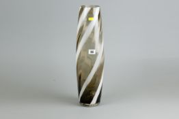 A smoky glass tall art vase of slightly bulbous form and with white swirled decoration, 19.5 ins (50