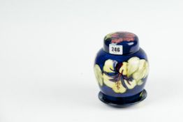 A Moorcroft ginger jar with lid `Hibiscus` pattern, 6.25 ins (16 cms) high. and a small matching