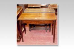 A 19th Century oblong topped mahogany fold over tea table on square tapered corner supports