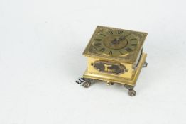 An 18th Century brass encased table clock, the circular 3.75 ins (8 cms) dial having Roman