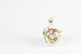 A Moorcroft cream ground narrow necked small vase with `Freesia` decoration, 5.25 ins (13 cms)