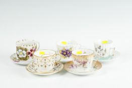 A collection of five late Victorian china moustache cups and saucers