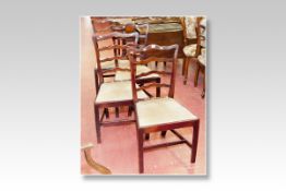 A set of four late 19th/early 20th Century mahogany ladder back dining chairs with drop-in seats