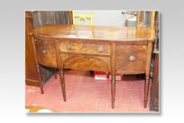 A William IV mahogany sideboard having a slightly bowed front with centre drawer and inset drawer
