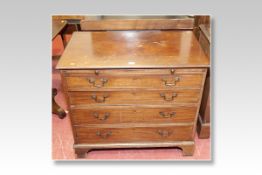A 19th Century mahogany chest of four long graduated drawers with top brush slide and bracket