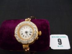 A lady`s nine carat gold circular dial cocktail watch having a twenty diamond bezel, white dial with