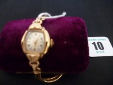 A lady`s nine carat gold encased near square dial Rotary wristwatch with twin strand nine carat gold