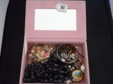 A pink fabric jewellery box with quantity of mixed dress jewellery