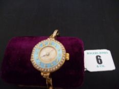 A lady`s circular dial early Rolex wristwatch having a blue enamel bezel with surrounding seed