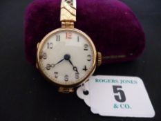 A lady`s nine carat gold encased circular dial Edwardian wristwatch with yellow and white metal