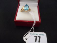 An eighteen carat gold dress ring with pear shaped aquamarine to triple split shoulders